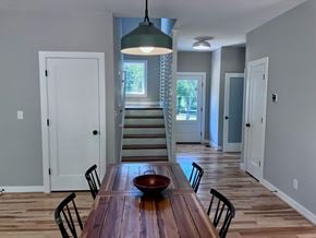 Charlottesville house for rent - A dining room with a wooden table and chairs.