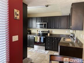 Murray condo for rent - A living room with a black couch, a coffee table, and a television.