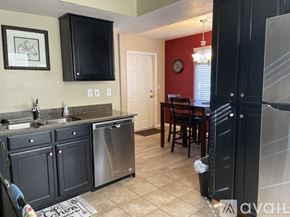 Murray condo for rent - A kitchen with black cabinets and a red wall.