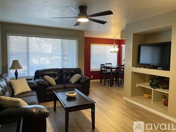 Murray condo for rent - A living room with a black leather couch and a wooden coffee table.