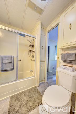 Rockledge house for rent - A white mobile home with a black door and windows is shown.