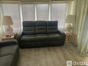 Rockledge house for rent - A bedroom with a bed, desk, and window.
