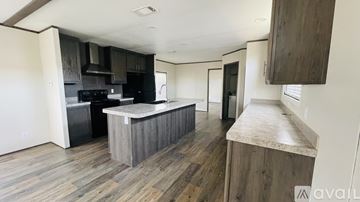 Pflugerville house for rent - A kitchen with a wooden floor and a counter.