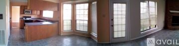 Grand Prairie house for rent - A kitchen with wooden cabinets and a large island with a sink.