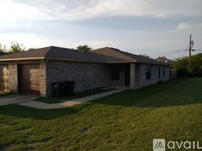 Fort Worth townhouse for rent - A house with a garage and a driveway.