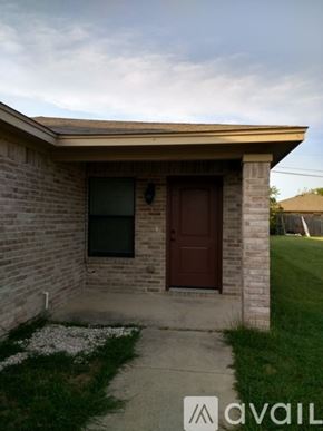 Fort Worth townhouse for rent - A small house with a brown door and a window.