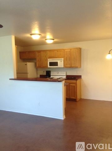 Fort Worth townhouse for rent - A kitchen with wooden cabinets and a white counter.