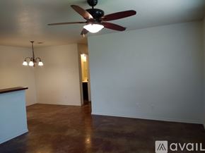 Fort Worth townhouse for rent - A room with a ceiling fan and a chandelier.