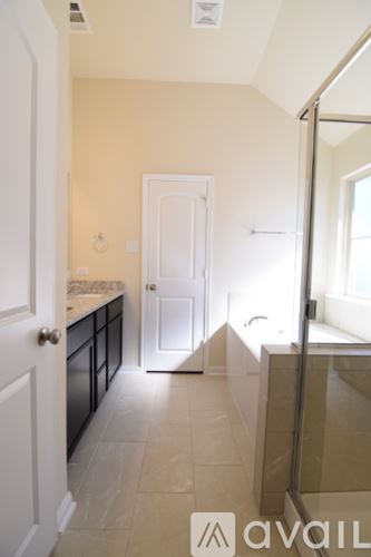 Temple house for rent - A modern kitchen with black cabinets and a white island.