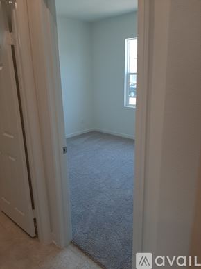 Riverside house for rent - A room with a carpeted floor and a door.