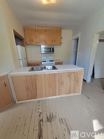 Frostburg apartment for rent - A kitchen with wooden cabinets and a white countertop.