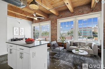 Dallas apartment for rent - A kitchen with white cabinets and a large window overlooking a cityscape.