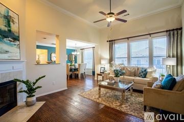Prosper apartment for rent - A living room with a fireplace, a sofa, a coffee table, and a painting on the wall.