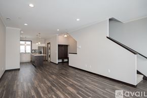 North Mankato apartment for rent - A spacious living room with wood flooring and a staircase on the right side.