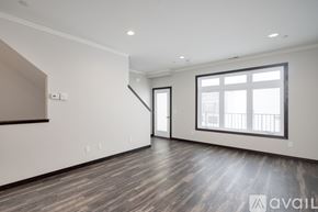 North Mankato apartment for rent - A spacious room with wooden flooring and a large window.