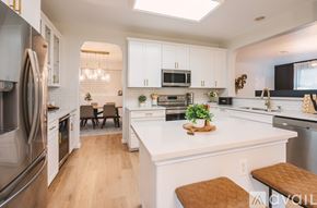 Georgetown house for rent - A modern kitchen with white cabinets and a large island.