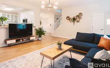 Georgetown house for rent - A living room with a blue couch and a television.