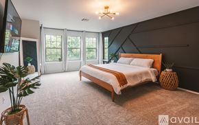 Georgetown house for rent - A bedroom with a large bed and a flat screen TV.