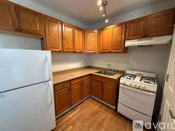 Chicago apartment for rent - A kitchen with white cabinets and a lot of items on the counter.