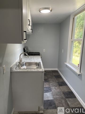 Syracuse apartment for rent - A kitchen with a sink and a window.