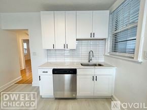 Chicago apartment for rent - A kitchen with white cabinets and a stainless steel dishwasher.