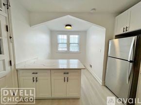 Chicago apartment for rent - A kitchen with white cabinets and a stainless steel refrigerator.