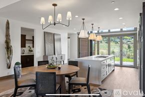 Heber City townhouse for rent - A modern dining room with a wooden table and chairs.