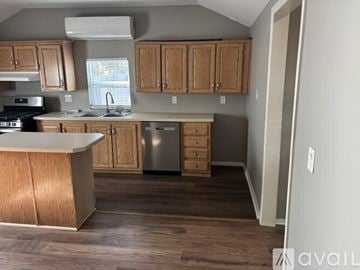 Calimesa house for rent - A kitchen with a fan, a window, and a trash bin.