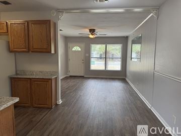 San Antonio house for rent - A kitchen area with wooden cabinets and a marble countertop.