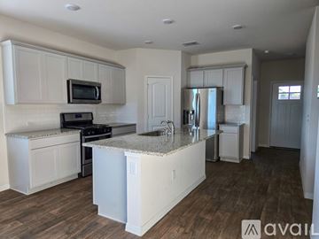 Georgetown house for rent - A kitchen with white cabinets and a granite countertop.