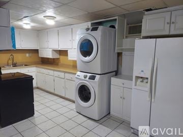 Gainesville house for rent - A white washing machine and refrigerator in a kitchen.