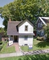 Clairton house for rent - A white house with a brown roof and a small front yard.
