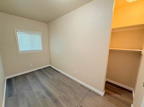 Merced house for rent - A room with a window and wooden flooring.