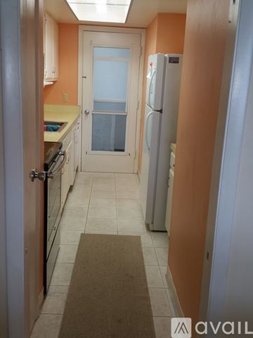 Punta Gorda apartment for rent - A kitchen with a refrigerator and a door.