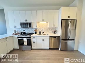 Chicago apartment for rent - A kitchen with white cabinets and stainless steel appliances.