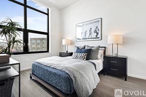 Chicago apartment for rent - A bedroom with a large bed and a framed picture on the wall.