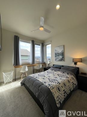 Silverthorne apartment for rent - A bedroom with a large bed and a mountain painting on the wall.