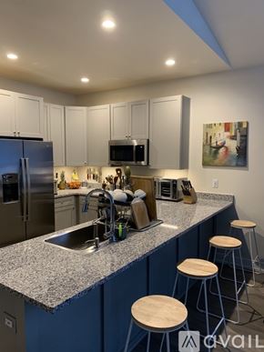 Silverthorne apartment for rent - A kitchen with a blue counter and white cabinets.