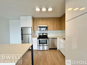Chicago apartment for rent - A modern kitchen with a stainless steel refrigerator, oven, and microwave.