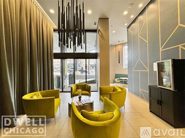 Chicago apartment for rent - A modern living room with yellow chairs and a television.