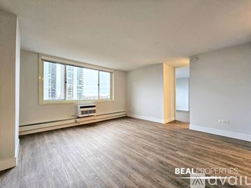 Chicago condo for rent - A kitchen with a refrigerator, microwave, and oven is shown in this image.