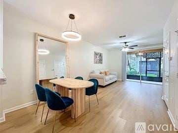 Sanford house for rent - A living room with a round wooden table and blue chairs.