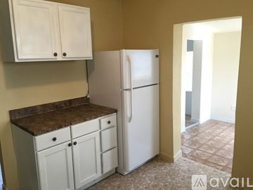 Haines City house for rent - A kitchen with a white refrigerator and cabinets.
