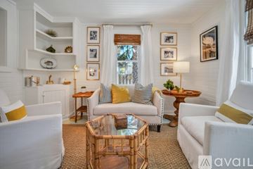 Savannah house for rent - A living room with white furniture and a glass coffee table.