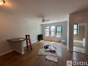 Chicago apartment for rent - A room with a fan, a ladder, and some tools on the floor.