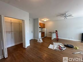 Chicago apartment for rent - A room with wooden floors and a ceiling fan is under renovation.