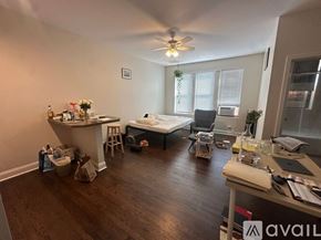 Chicago apartment for rent - A room with a bed, desk, and chair.