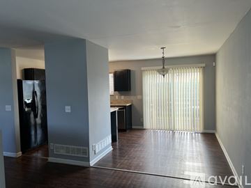 Omaha house for rent - A living room with a television and a bar area.