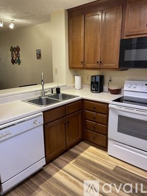 Boone apartment for rent - A kitchen with white appliances and wooden cabinets.