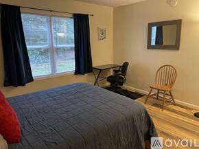 Boone apartment for rent - A bedroom with a bed, chair, and window.